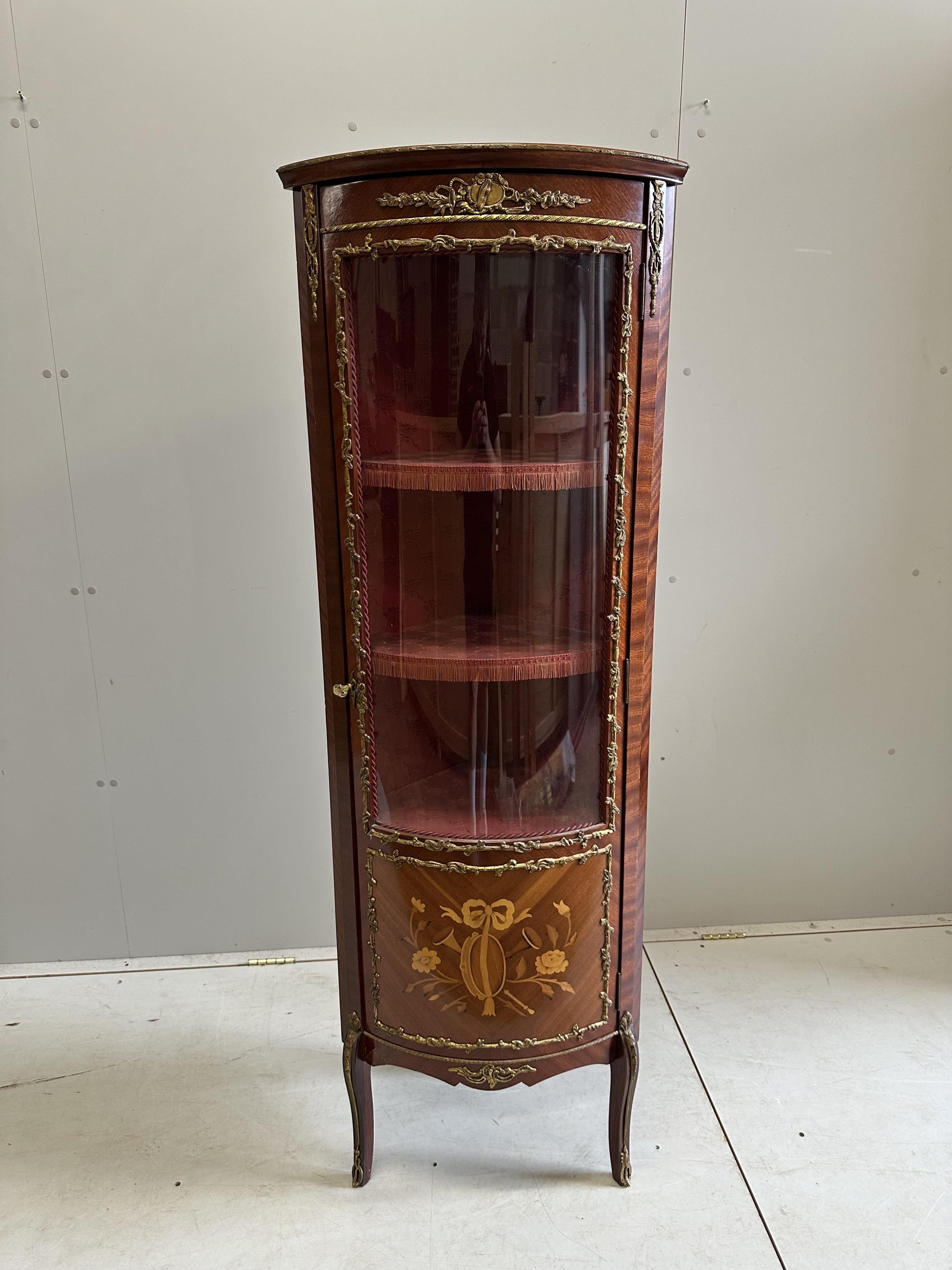 A Louis XVI style marquetry inlaid and gilt metal mounted mahogany corner cabinet, width 52cm, depth 38cm, height 157cm. Condition - good